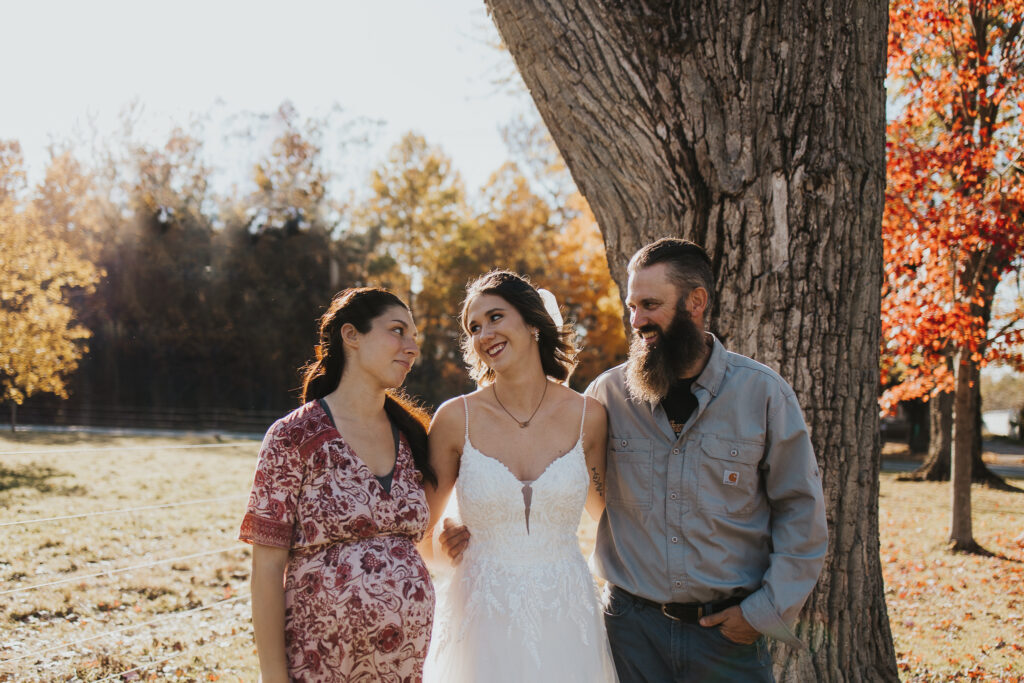 bride poses with family before ceremony