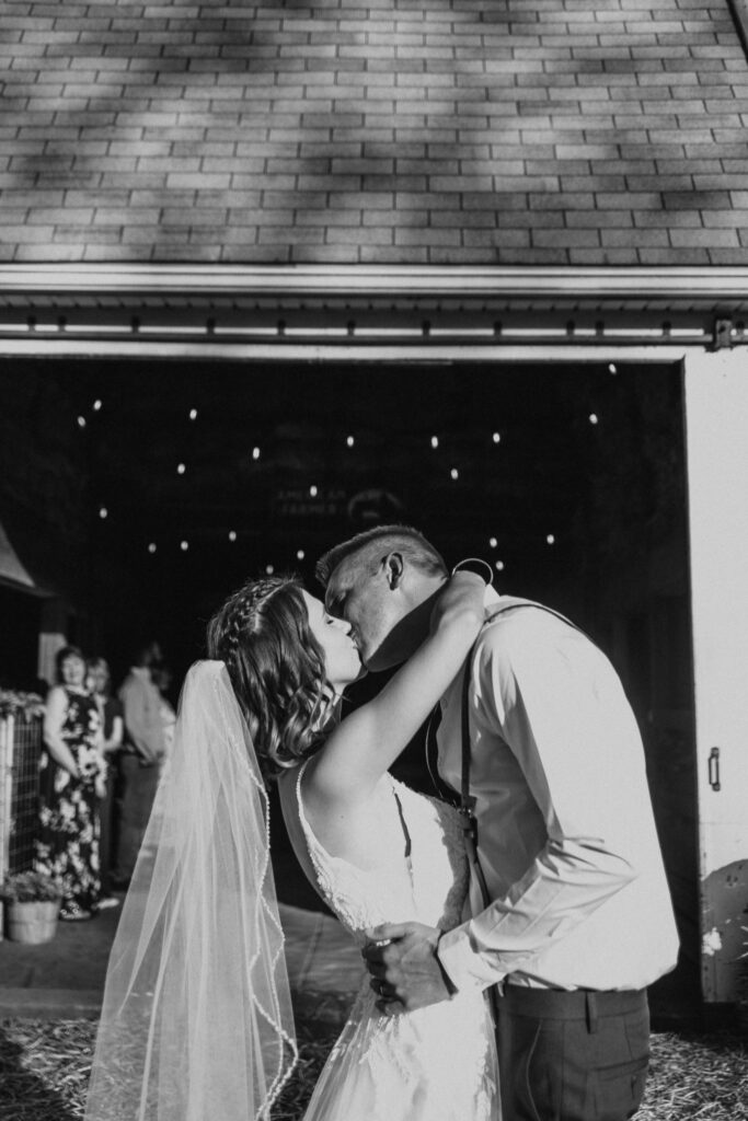 couple kiss after ceremony of their intimate backyard wedding