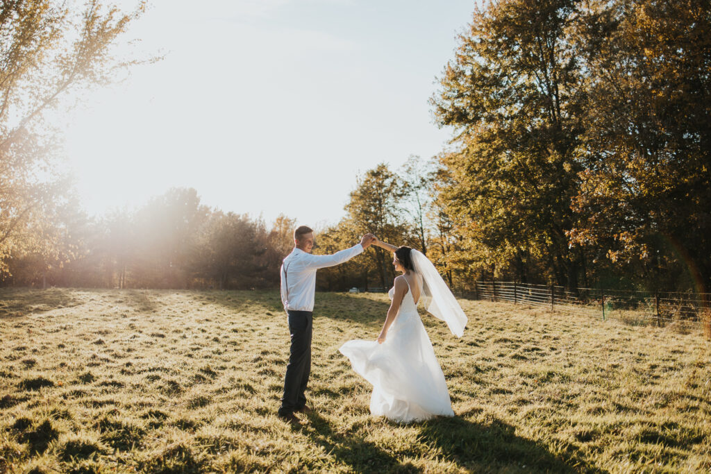 couple spins in the pasture at sunset