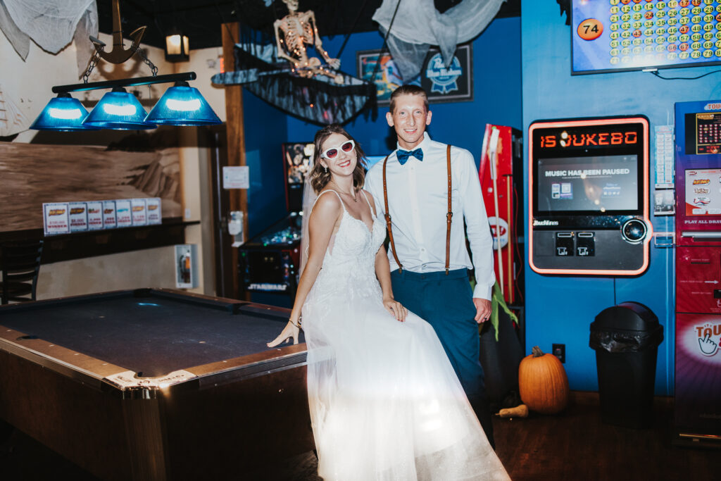 couple pose in a local bar by the jukebox