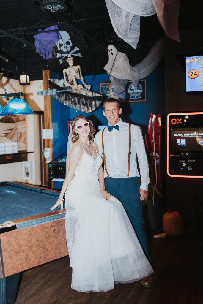 couple pose in a local bar by the jukebox