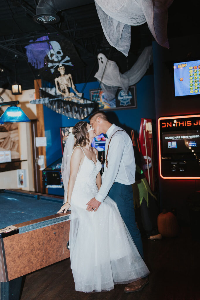 couple kiss in a local bar by the jukebox