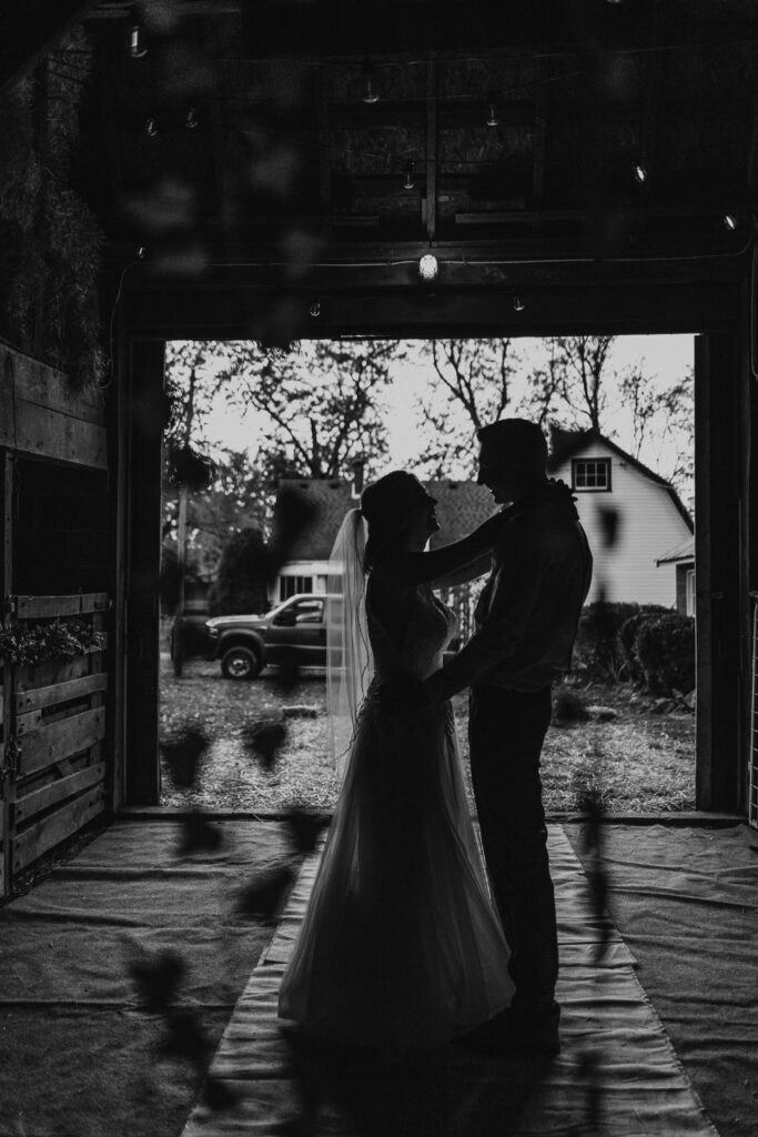 couple dance together during intimate backyard wedding