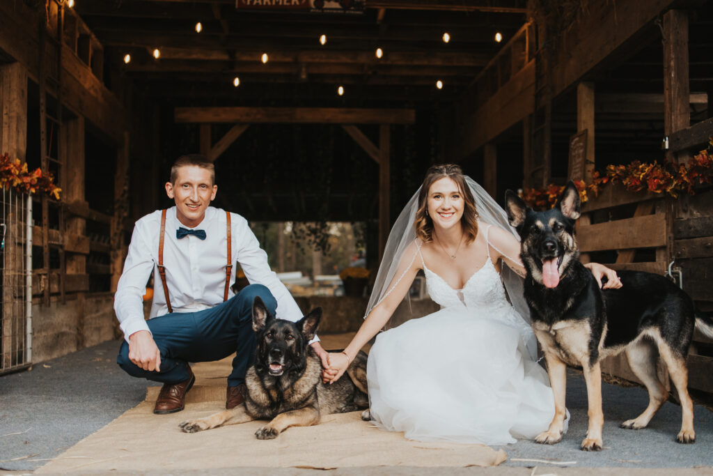 couple pose with their dogs