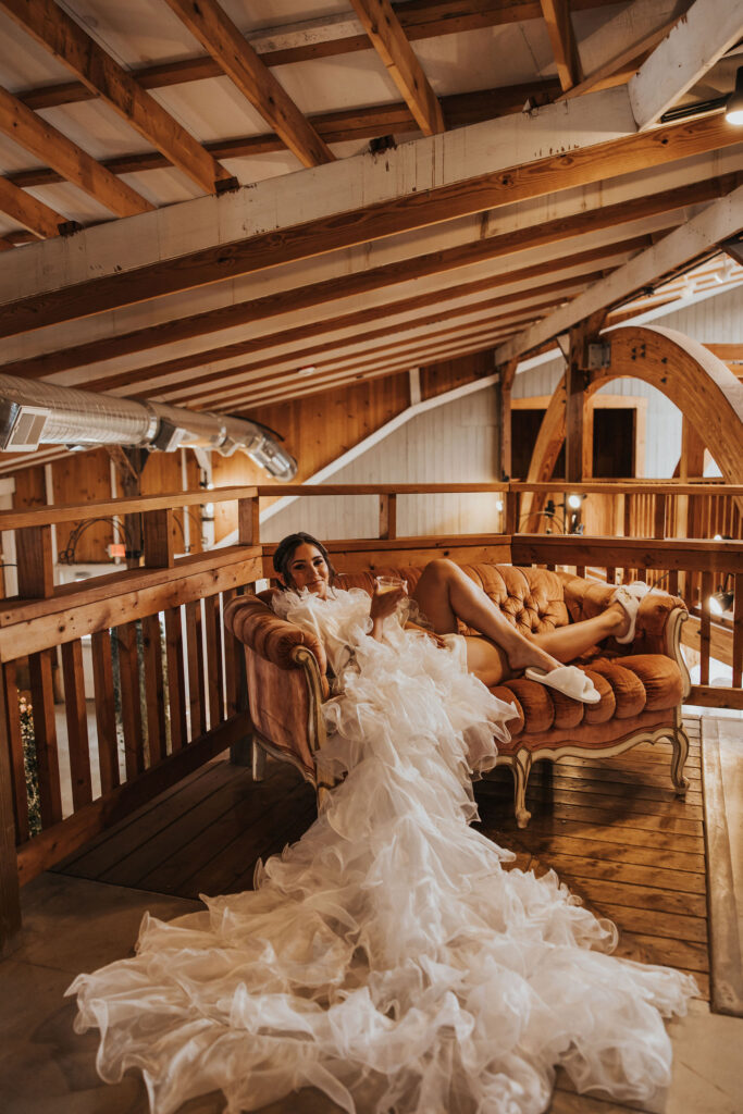 bridal boudoir bride seated on leather couch