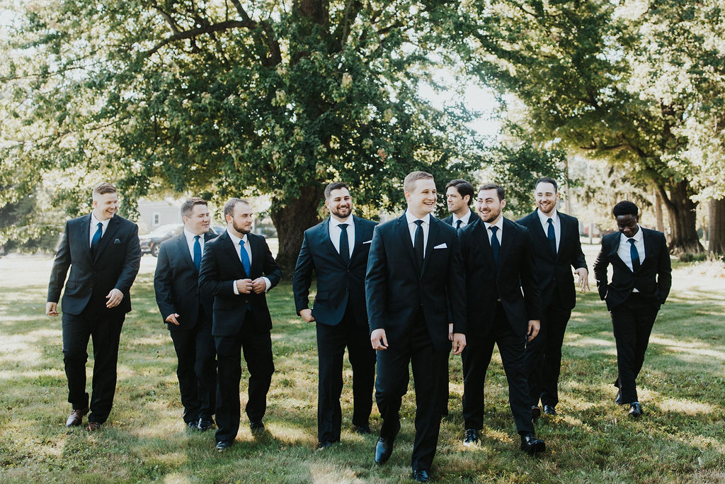 groom walks with groomsmen