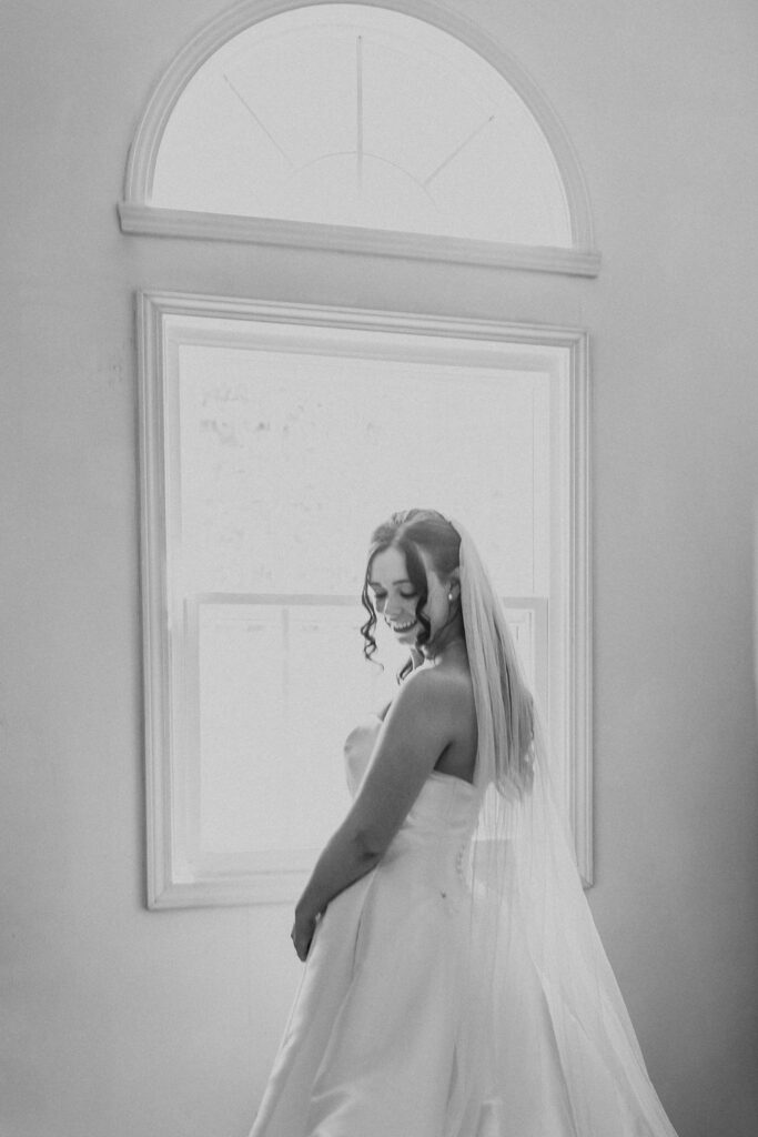 bride poses in wedding veil 