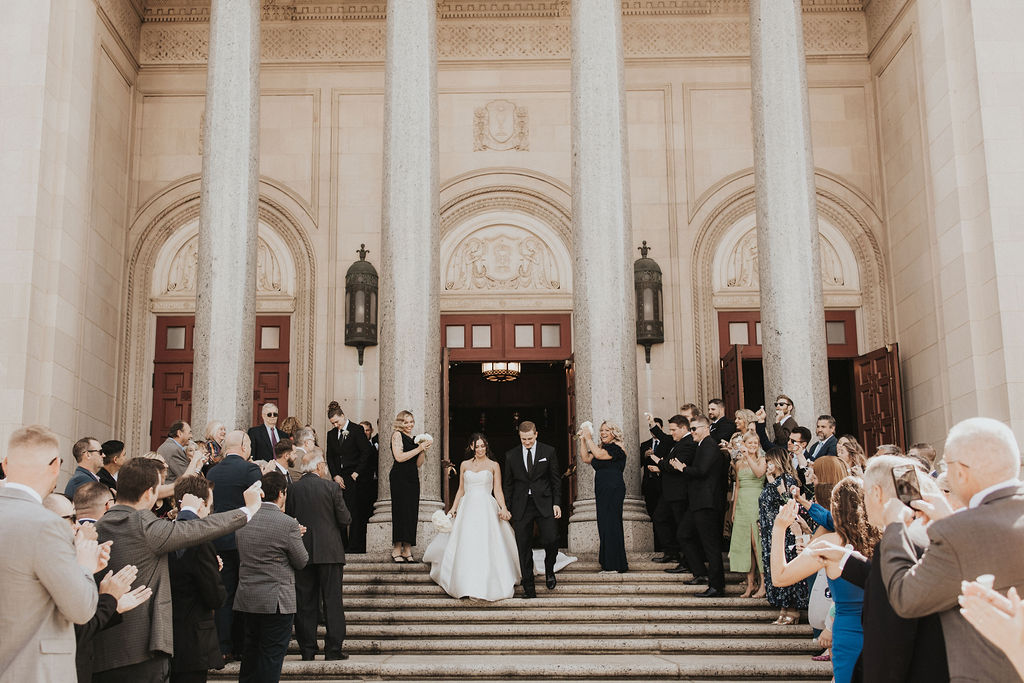 couple exits wedding church steps