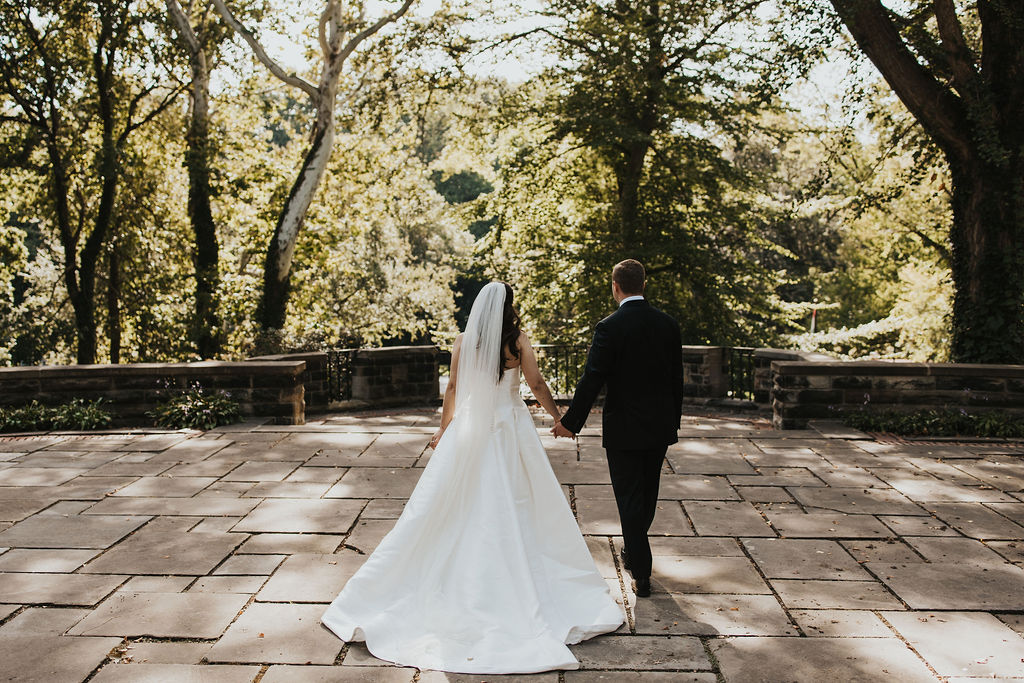 couple walks holding hands at Cleveland Cultural Gardens