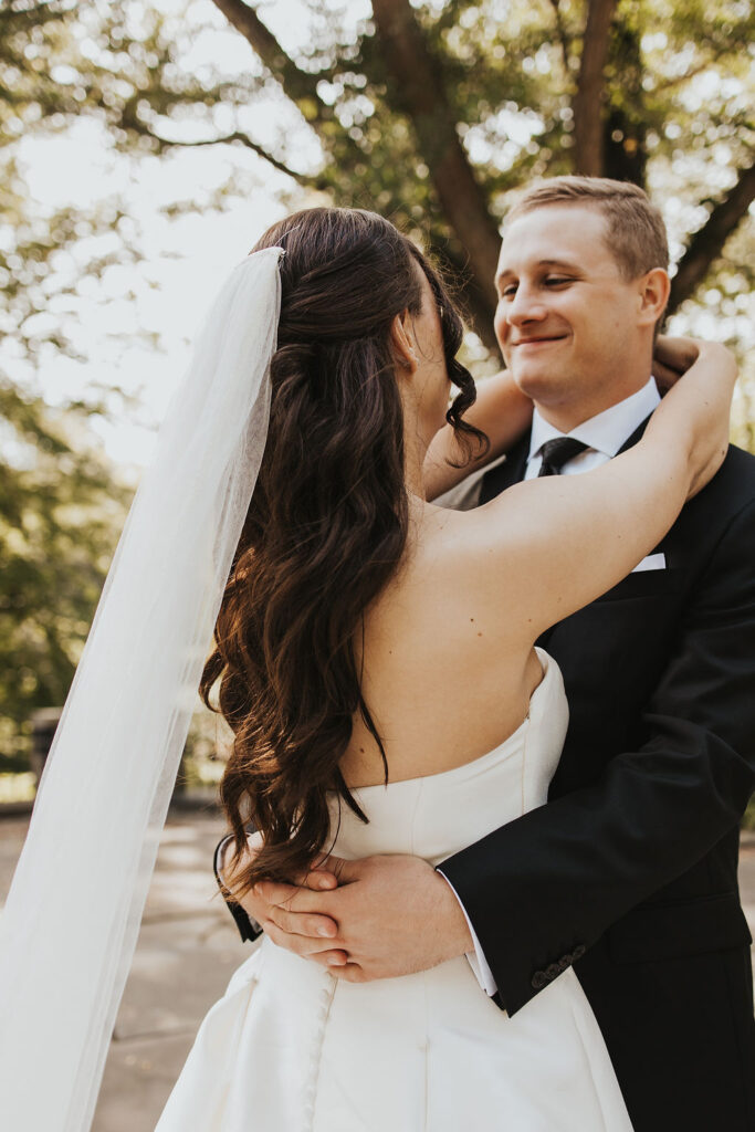 couple embraces at sunset outdoor wedding 