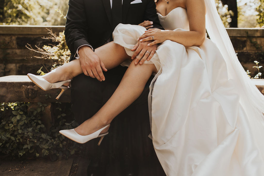 bride sits on groom's lap