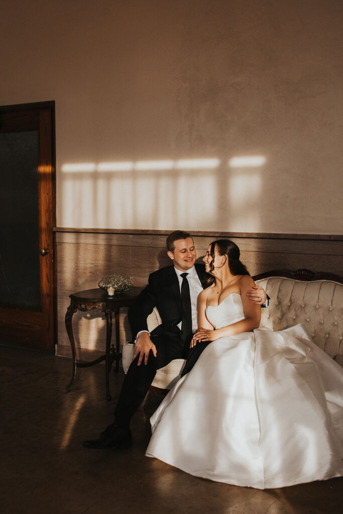 couple sits together after wedding ceremony