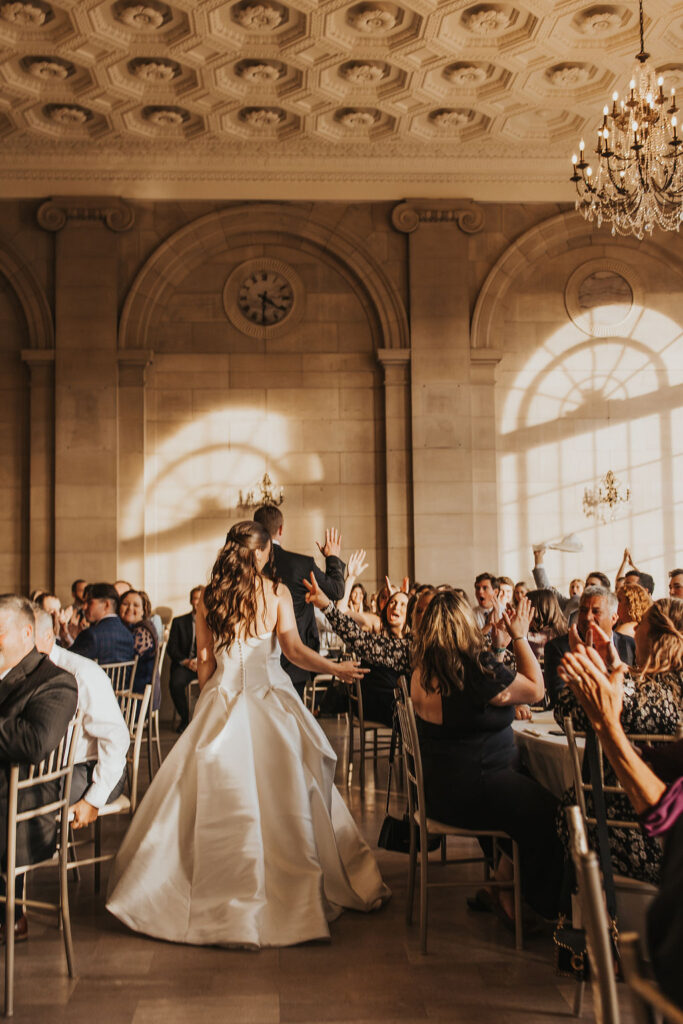 couple enters reception room in one of their Cleveland wedding locations
