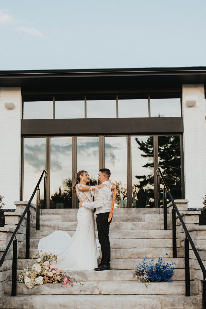 couple embraces at golf course wedding venue