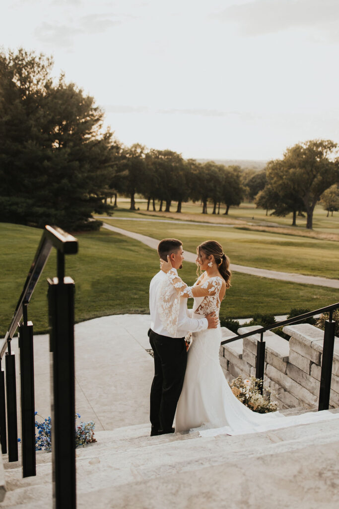 couple embraces at golf course wedding venue