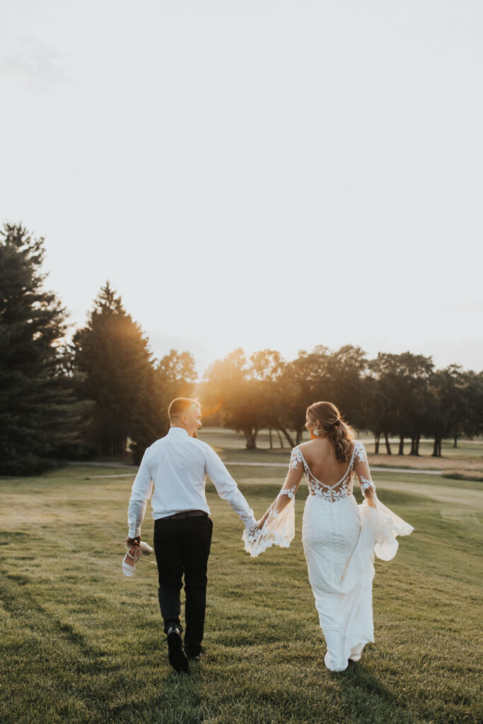 couple walks together at golf course wedding venue