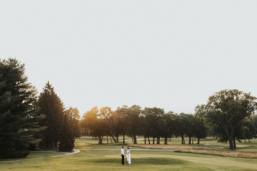 couple walks together at golf course wedding venue