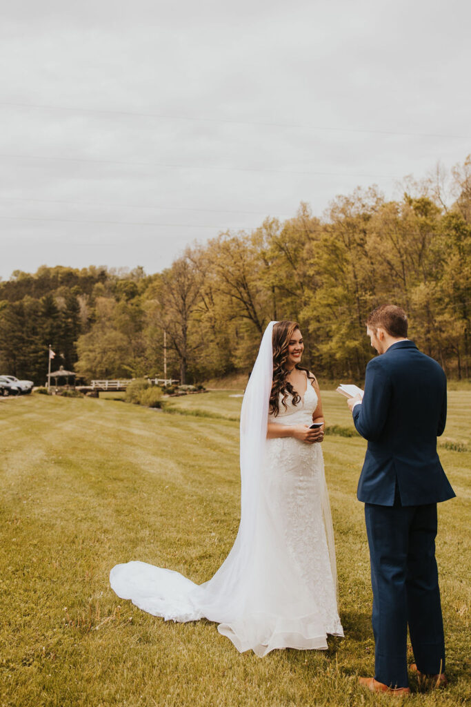 couple exchanges vows during outdoor wedding