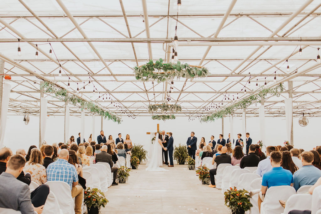 couple exchanges vows during wedding ceremony at greenhouse Central Ohio wedding venues