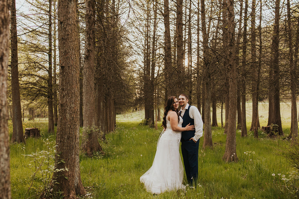 couple poses in woods at Central Ohio wedding venues