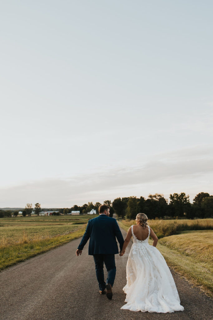 couple walks down road at Harvest Moon of the Central Ohio wedding venues