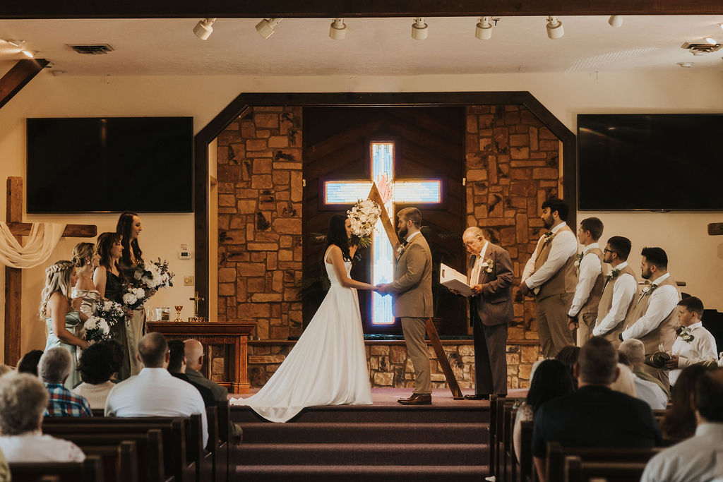 couple exchanges vows during church wedding ceremony