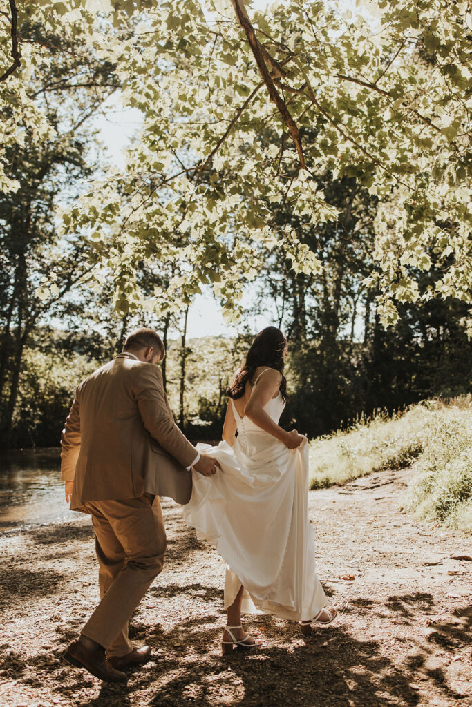 couple walks along path at forest elopement