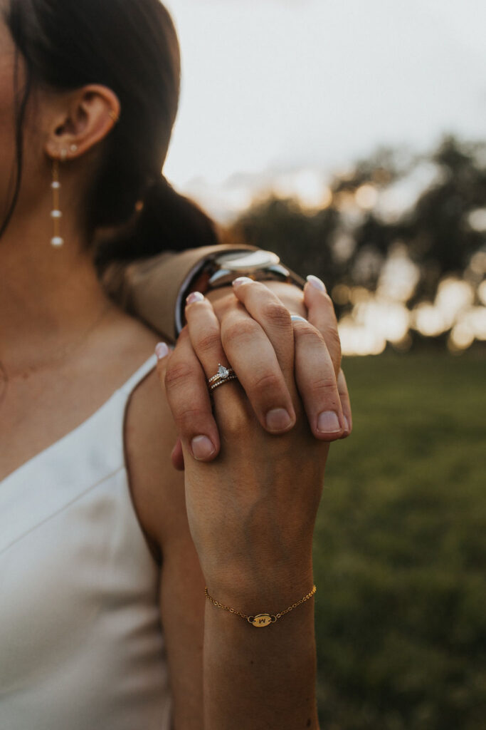 couple holds hands during sunset wedding photos