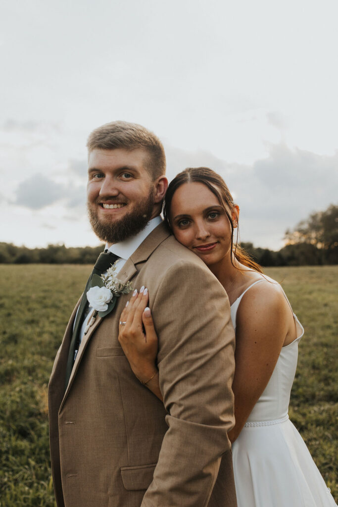 couple embraces during sunset wedding photos