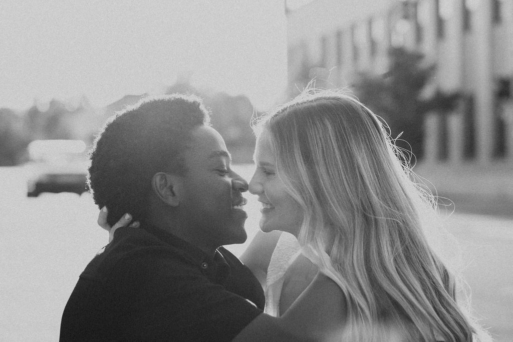 couple kisses during city engagement session