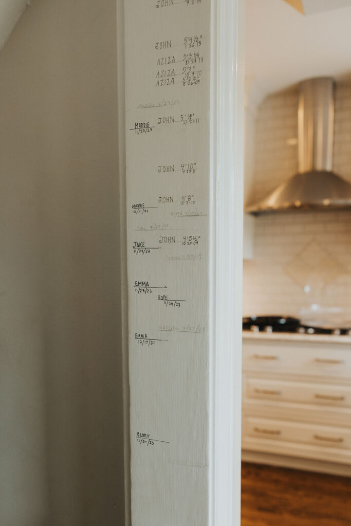 wall markings of kid heights in family home