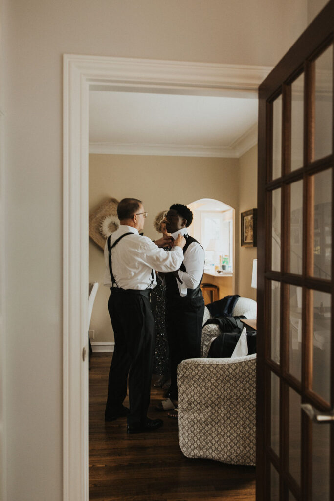 groom gets ready with his dad in family home