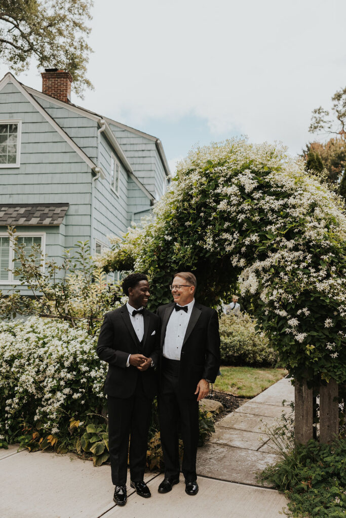 groom gets ready with his dad outside of family home