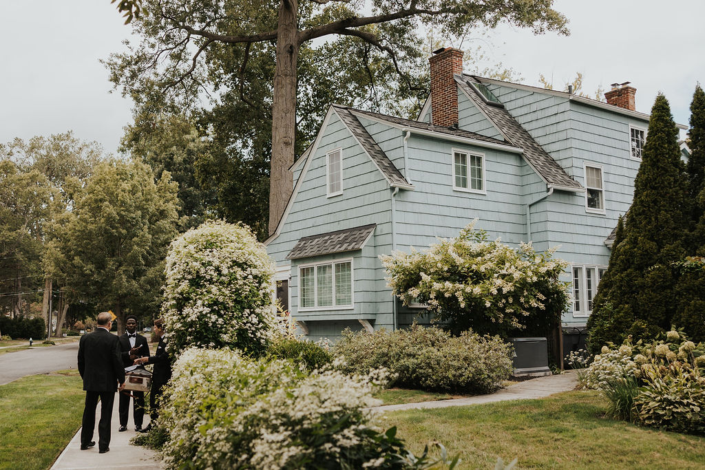 groom gets ready with his dad outside of family home