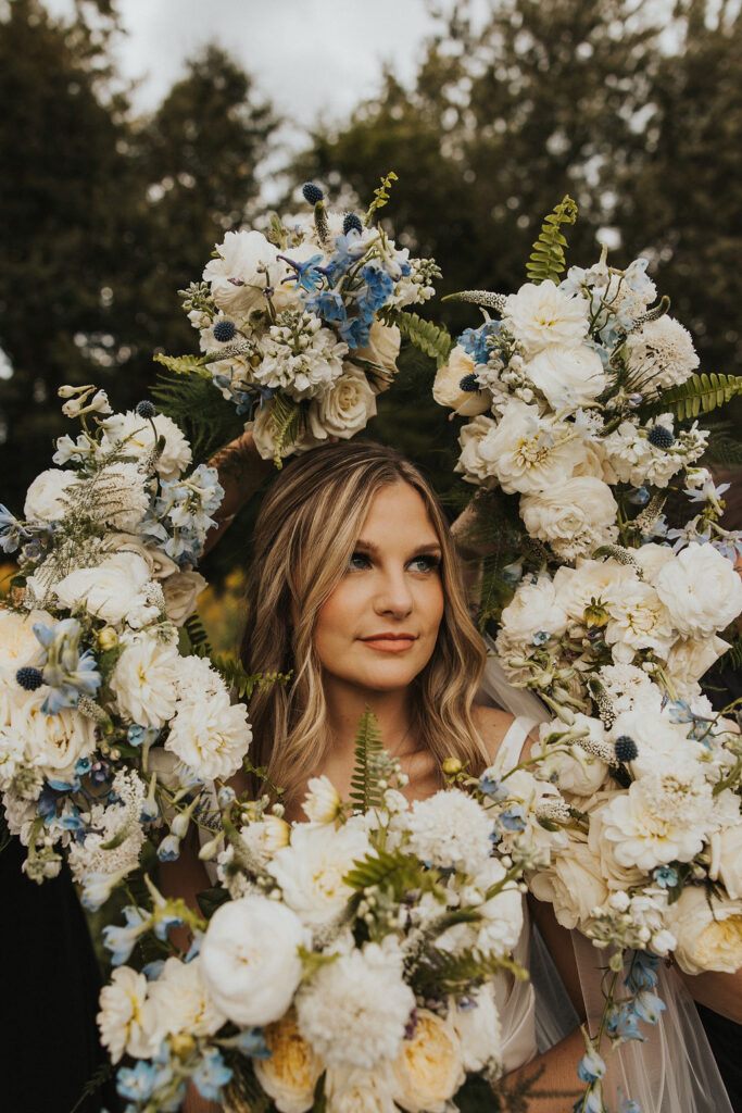 bride poses within wedding bouquet halo