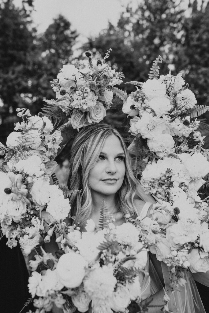 bride poses within wedding bouquet halo