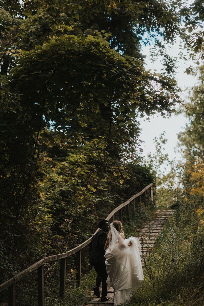 couple walks along outdoor park for wedding portraits