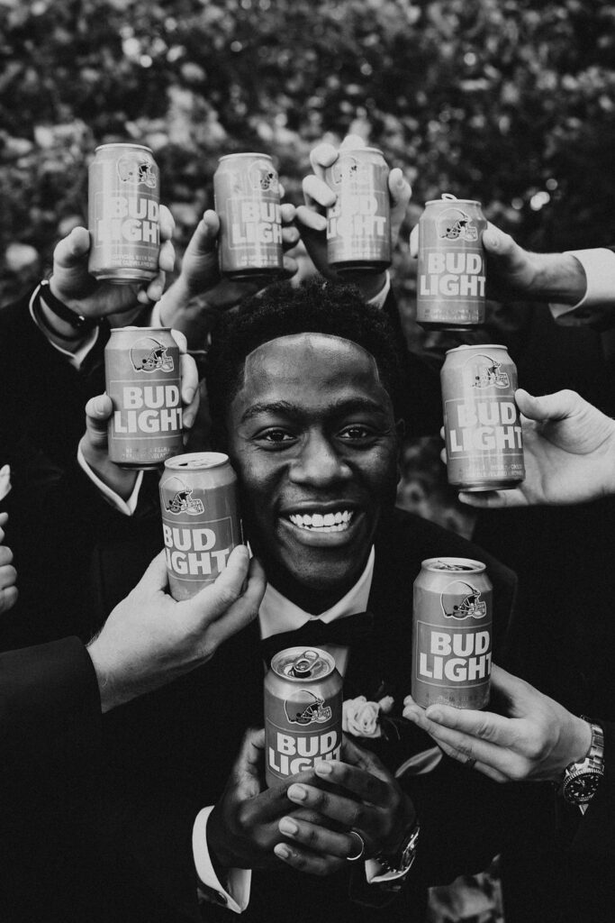 groom poses within beer can halo