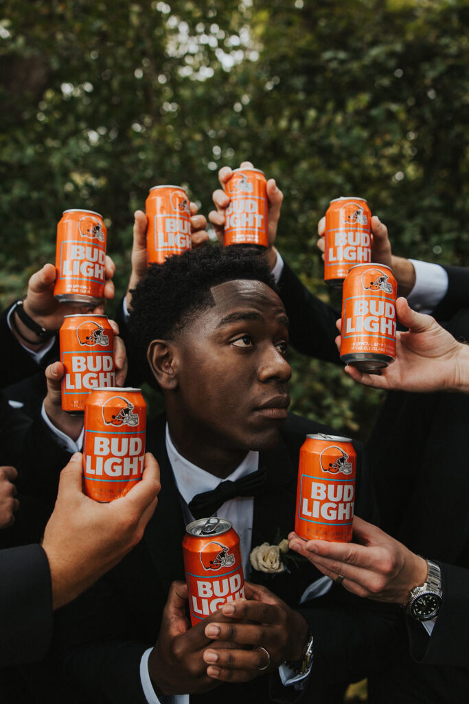 groom poses within beer can halo