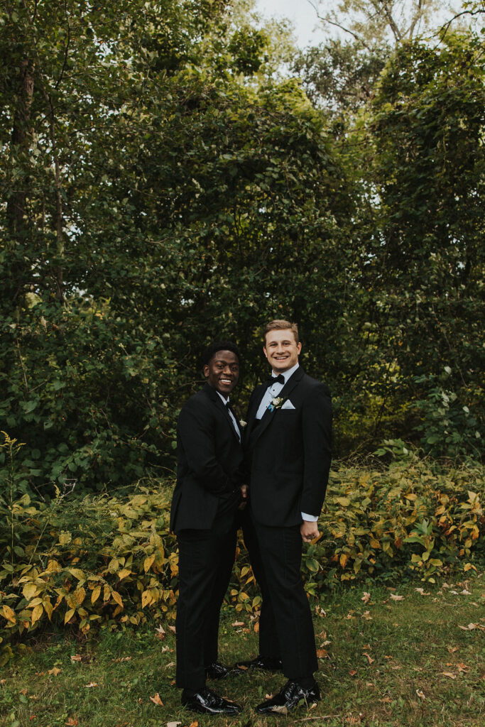 groomsmen shake hands in funny pose