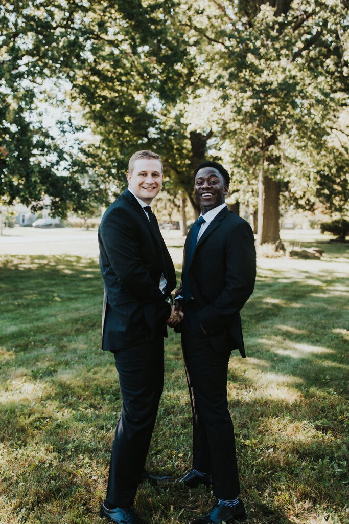 groomsmen shake hands in funny pose