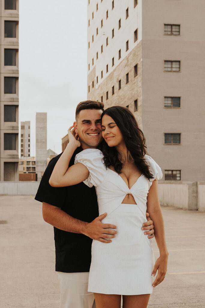 couple embrace on rooftop parking garage in downtown columbus ohio