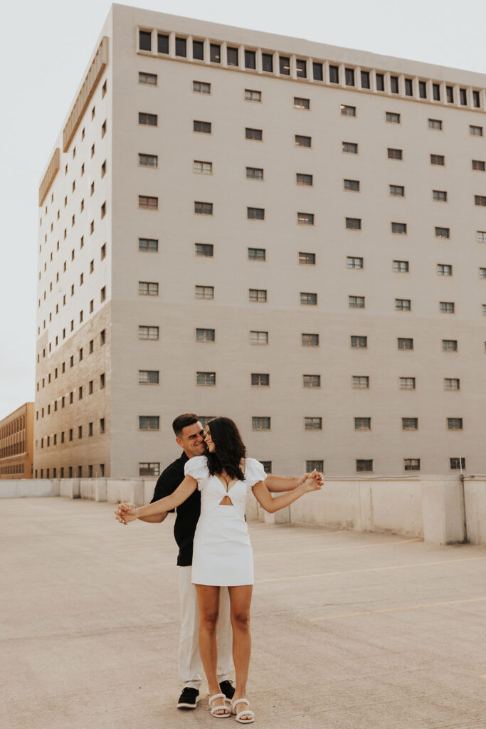 couple pose on rooftop parking garage in downtown columbus ohio