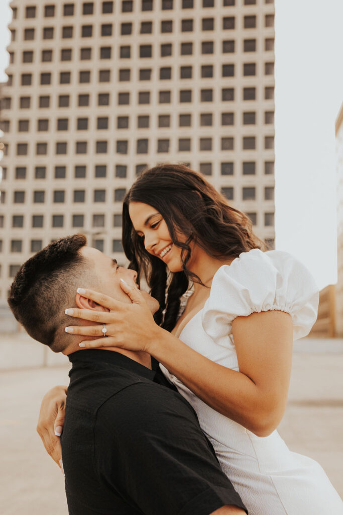couple embrace on rooftop parking garage