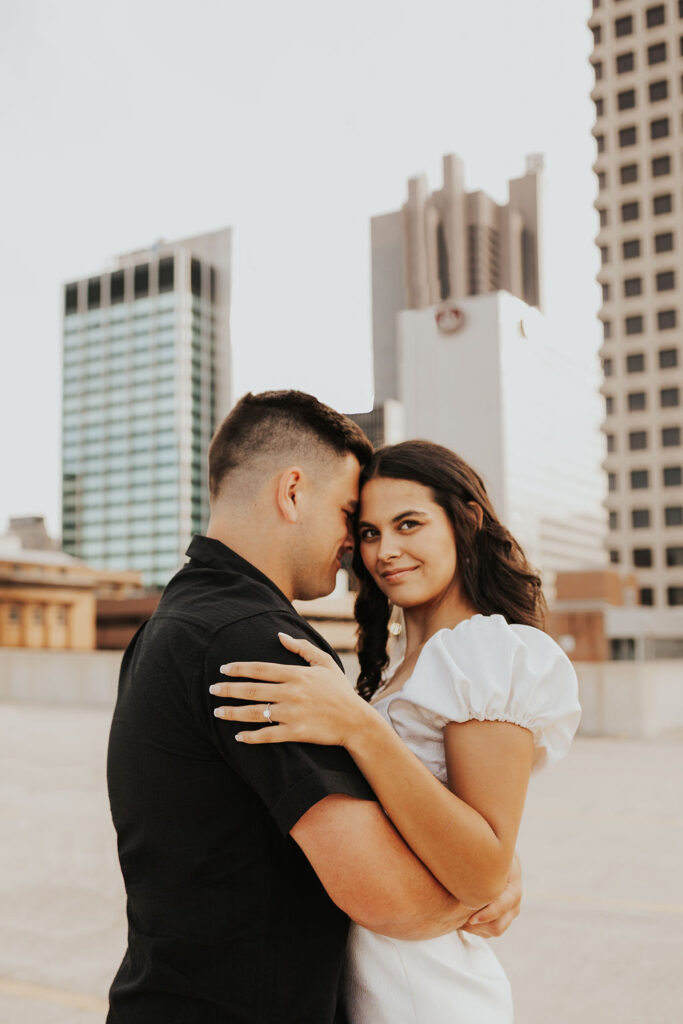 couple embrace on rooftop parking garage in downtown columbus ohio