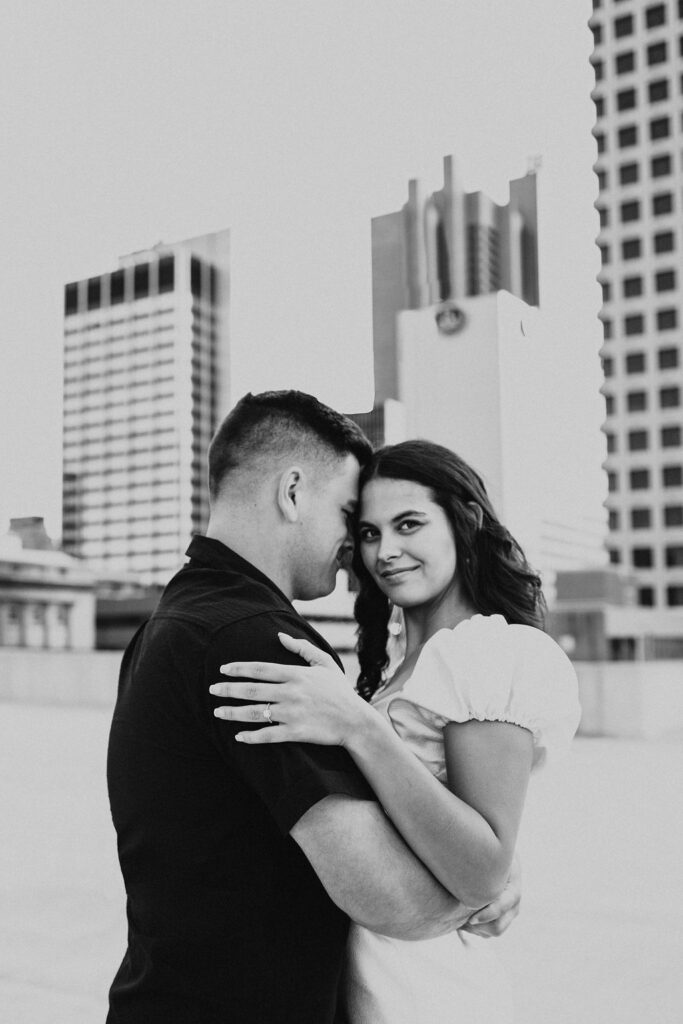 couple embrace on rooftop parking garage in downtown columbus ohio