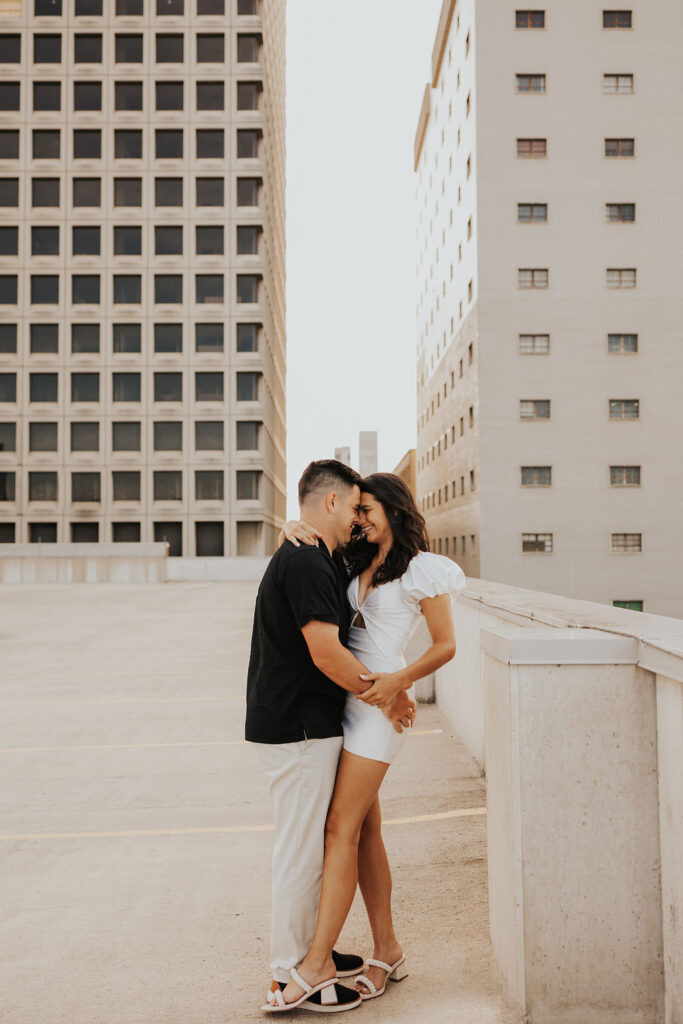 couple embrace on rooftop parking garage