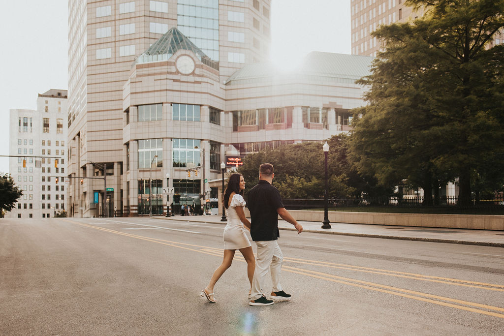 couple walks across the street in downtown columbus ohio