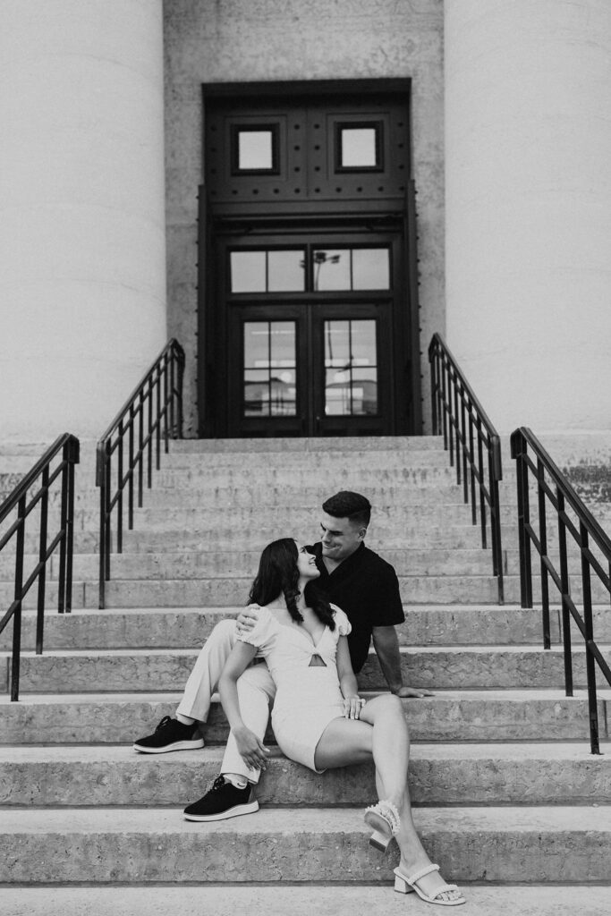 couple sit on the steps in front of Ohio Statehouse