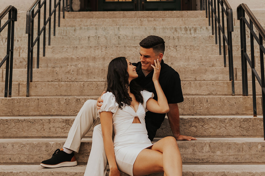 couple sitting on steps in front of Ohio Statehouse